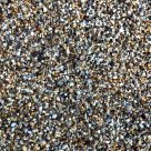 作者沈砚在窗边翻阅影像资料的工作照，光线从侧面落在纸页上